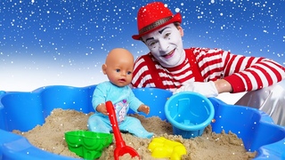 Baby Born spielt im Sandkasten. Lustiges Spielzeug Video mit dem Clown